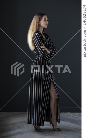 young beautiful woman on a dark background, full length studio shot young beautiful woman on a dark background, full length studio shot 140625174