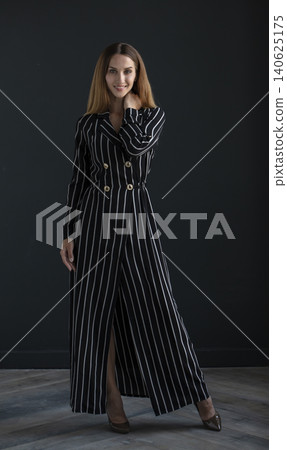 young beautiful woman on a dark background, full length studio shot young beautiful woman on a dark background, full length studio shot 140625175
