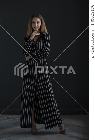 young beautiful woman on a dark background, full length studio shot young beautiful woman on a dark background, full length studio shot 140625176