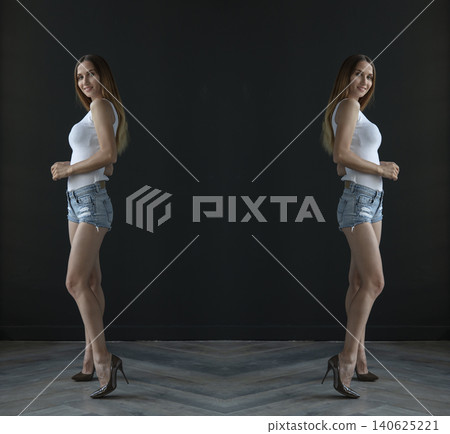 young beautiful woman on a dark background, full length studio shot 140625221