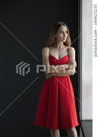 young beautiful woman on a dark background, full length studio shot 140625235