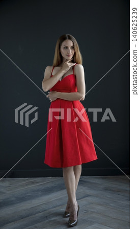 young beautiful woman on a dark background, full length studio shot young beautiful woman on a dark background, full length studio shot 140625239