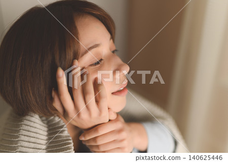The profile of a young woman lost in thought The profile of a young woman lost in thought 140625446