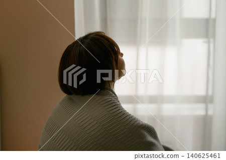 Rear view of a woman looking out the window 140625461