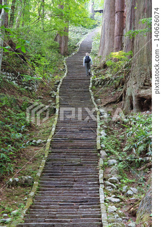 Surrounded by cedar forests, the historic, long stone staircase leading to Mount Haguro stretches on endlessly. Surrounded by cedar forests, the historic, long stone staircase leading to Mount Haguro stretches on endlessly. 140626074