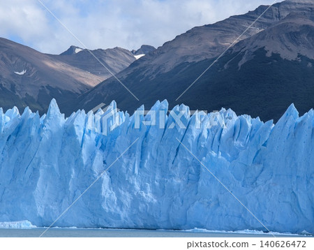 Perito Moreno Glacier with sharp blue ice peaks and mountain backdrop Perito Moreno Glacier with sharp blue ice peaks and mountain backdrop 140626472