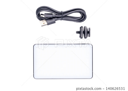 permanent video light kit with a rectangular led panel a black cable and an adapter permanent video light kit with a rectangular led panel a black cable and an adapter 140626531