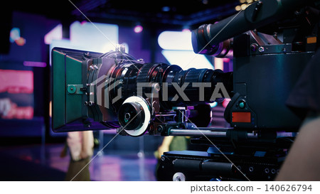 Behind the scenes of movie shooting or video production at studio with high quality camera gimbal or tripod equipment set up and professional film crew team or camera operator with flare lighting. Behind the scenes of movie shooting or video production at studio with high quality camera gimbal or tripod equipment set up and professional film crew team or camera operator with flare lighting. 140626794