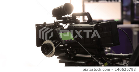 Behind the scenes of movie shooting or video production at studio with high quality camera gimbal or tripod equipment set up and professional film crew team or camera operator with flare lighting. Behind the scenes of movie shooting or video production at studio with high quality camera gimbal or tripod equipment set up and professional film crew team or camera operator with flare lighting. 140626798