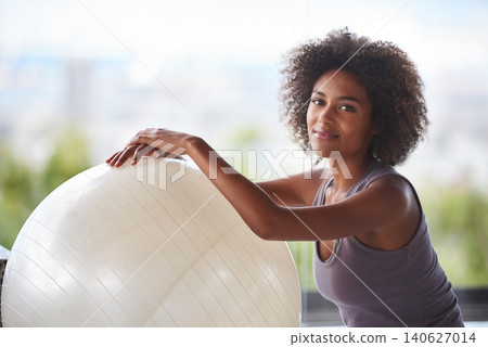 Woman, portrait and exercise ball for fitness and wellness in studio with smile for health and break. Face of a happy and young African person with workout, pilates and balance for strength practice Woman, portrait and exercise ball for fitness and wellness in studio with smile for health and break. Face of a happy and young African person with workout, pilates and balance for strength practice 140627014