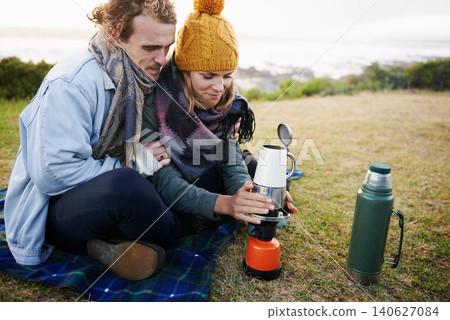 Happy couple, coffee and camping together in nature, travel and romantic getaway with bonding by beach. Man, woman or love on vacation with espresso on gas, countryside or relax on grass for drink Happy couple, coffee and camping together in nature, travel and romantic getaway with bonding by beach. Man, woman or love on vacation with espresso on gas, countryside or relax on grass for drink 140627084