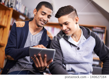 Tablet, students and brainstorming for project in library and diversity for knowledge in university. Young men, technology or collaboration for assignment or online research for education in college Tablet, students and brainstorming for project in library and diversity for knowledge in university. Young men, technology or collaboration for assignment or online research for education in college 140627164