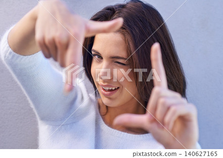 Happy woman, portrait and framing face with hands for photography, selfie or capture on a gray studio background. Young female person or model with smile or frame for picture moment, memory or photo Happy woman, portrait and framing face with hands for photography, selfie or capture on a gray studio background. Young female person or model with smile or frame for picture moment, memory or photo 140627165