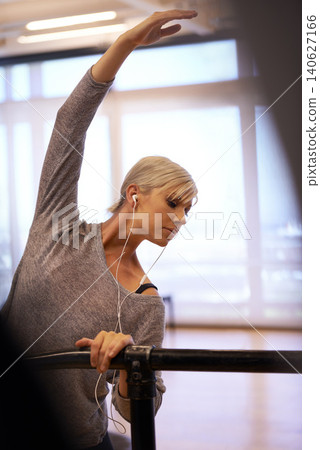 Earphone, ballet and woman with body stretch in dance studio for performance, show or theater rehearsal. Art, balance or dancer with stretching pole for ballroom, fitness or warm up stage training Earphone, ballet and woman with body stretch in dance studio for performance, show or theater rehearsal. Art, balance or dancer with stretching pole for ballroom, fitness or warm up stage training 140627166