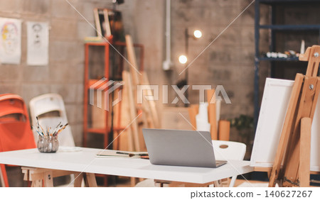Female artist wears black hat posing near picture indoor the studio Female artist wears black hat posing near picture indoor the studio 140627267