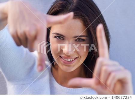 Portrait, smile and woman with finger frame, focus and studio for creative fashion photography. Perspective, hand gesture and girl showing happy face, casual style and view finder on blue background. Portrait, smile and woman with finger frame, focus and studio for creative fashion photography. Perspective, hand gesture and girl showing happy face, casual style and view finder on blue background. 140627284