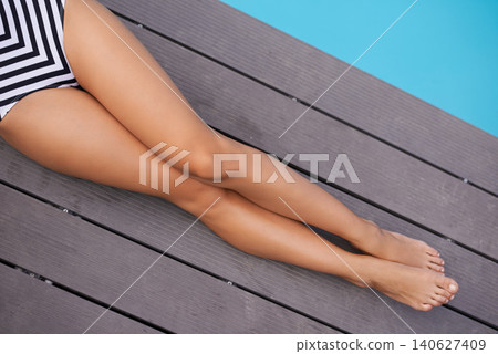 Summer, fashion and legs of woman on deck at pool to relax on luxury holiday or vacation in bikini. Calm, above and person sitting poolside at hotel, villa or outdoor to enjoy water and sunshine Summer, fashion and legs of woman on deck at pool to relax on luxury holiday or vacation in bikini. Calm, above and person sitting poolside at hotel, villa or outdoor to enjoy water and sunshine 140627409