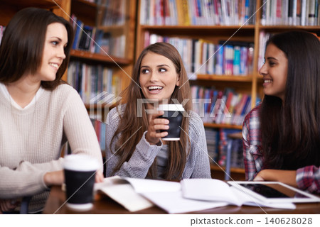 Women, students and coffee break for discussion in library and relax for bonding together in university. Friends, learning or collaboration for assignment or drink cocoa for inspiration in college 140628028