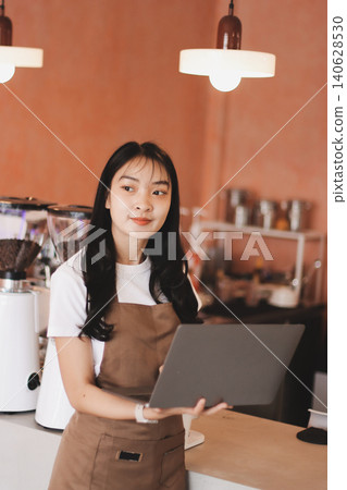 Young woman at barista school learning how to make espresso coffee. 140628530