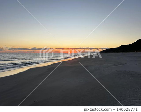 輕柔的海浪拍打著沙灘,夕陽西下。 輕柔的海浪拍打著沙灘,夕陽西下。 140628771