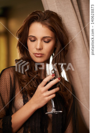 Young woman, glass and wine to relax in fashion lingerie and curtain in bedroom on vacation. Model, trendy underwear and alcohol drink for wellness on weekend and calm in elegant clothes in apartment Young woman, glass and wine to relax in fashion lingerie and curtain in bedroom on vacation. Model, trendy underwear and alcohol drink for wellness on weekend and calm in elegant clothes in apartment 140628873