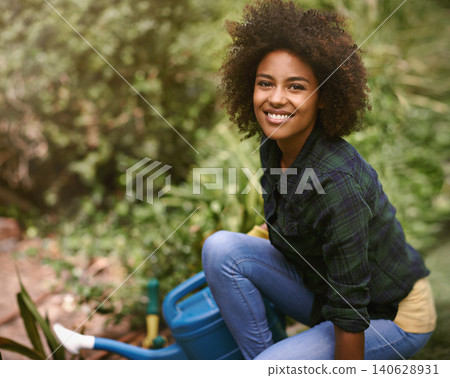 Woman, gardening and portrait with water can, plants and happy for spring, outdoor and earth. Girl, African person and smile on ground for growth, development and nature with ecology in backyard 140628931