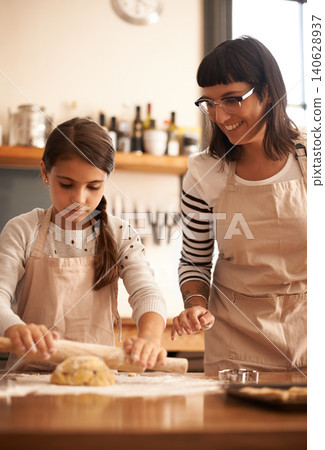 Mother, kid and happy with dough to bake biscuits in kitchen for easter season or bonding, child development and growth. Home, family and flower for cookies with fun, teaching and support for hobby Mother, kid and happy with dough to bake biscuits in kitchen for easter season or bonding, child development and growth. Home, family and flower for cookies with fun, teaching and support for hobby 140628937