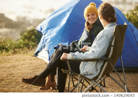 Conversation, camping and couple by tent on vacation, adventure or holiday in woods. Smile, love and young man and woman talking, bonding and relaxing in outdoor forest for weekend trip in nature. Conversation, camping and couple by tent on vacation, adventure or holiday in woods. Smile, love and young man and woman talking, bonding and relaxing in outdoor forest for weekend trip in nature. 140629093