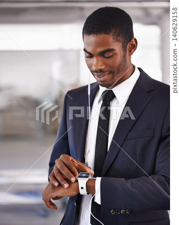 Check, earphones or businessman with smart watch for time technology or device for schedule. Travel, formal outfit or black man with network gadget for radio or music app, podcast or notification Check, earphones or businessman with smart watch for time technology or device for schedule. Travel, formal outfit or black man with network gadget for radio or music app, podcast or notification 140629158
