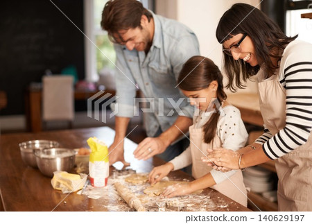 Mother, father and girl with baking cake in kitchen with oven, happiness and teaching with support. Family, parents and child with helping, learning and bonding with cooking for dinner and cookies Mother, father and girl with baking cake in kitchen with oven, happiness and teaching with support. Family, parents and child with helping, learning and bonding with cooking for dinner and cookies 140629197