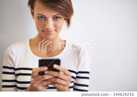 Teen, studio or portrait with smartphone, texting and face for social media or communication. Girl, phone and smile with technology, online connection or internet message isolated on white background 140629258