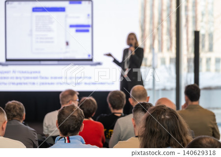 Business conference presentation with speaker addressing seated audience during corporate tech seminar Business conference presentation with speaker addressing seated audience during corporate tech seminar 140629318
