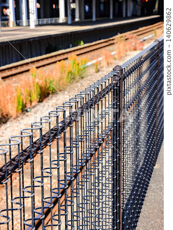 Brown steel fence along the walkway, close to the main road. Brown steel fence along the walkway, close to the main road. 140629862