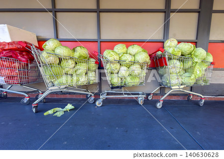 Cabbages in a shopping trolley on a footpath at a shopping centre carpark Cabbages in a shopping trolley on a footpath at a shopping centre carpark 140630628