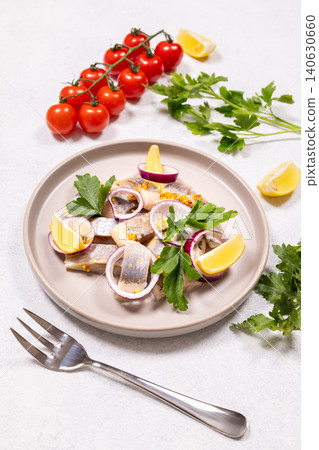 Herring salad with red onion, lemon, parsley, and tomatoes Herring salad with red onion, lemon, parsley, and tomatoes 140630660