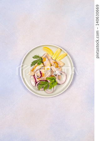 Marinated herring fillets with red onion and mustard seeds Marinated herring fillets with red onion and mustard seeds 140630669