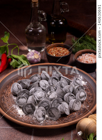 Black pelmeni dumplings with dough flour spices for cooking Black pelmeni dumplings with dough flour spices for cooking 140630691