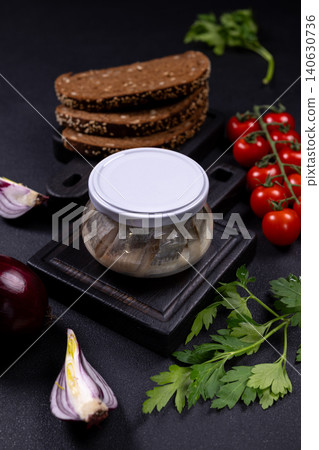 Pickled herring in jar with rye bread 140630736