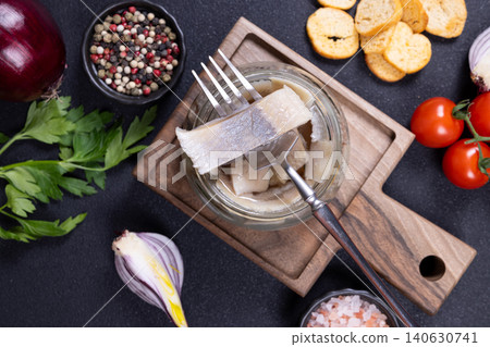 Herring fillets in a jar with various ingredients Herring fillets in a jar with various ingredients 140630741