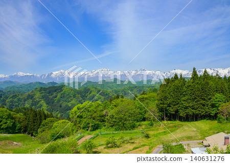 The Northern Alps amidst fresh greenery and lingering snow [Ogawa Village] 140631276