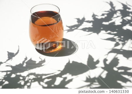 Barley tea in the sunlight filtering through the trees Barley tea in the sunlight filtering through the trees 140631330