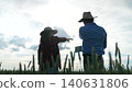 Farmers Discussing Future Plans, Rural People in Wheat Field, Agriculture Consultation Outdoors, Farm Work Planning, Man and Woman Farmers Talking, Countryside Crop Management, Modern Agriculture 140631806