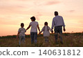mother father children boy girl park sunset, man woman toddlers outdoors, Happy family walking at sunset, Family enjoying evening walk, Parents and children together in nature, Family bonding outdoors 140631812