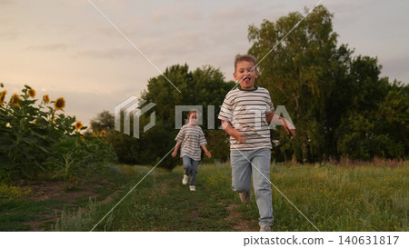 Happy children running in a summer field, Smiling boy and girl playing outdoors, Kids enjoying nature and fresh air, Siblings having fun together at sunset, Carefree childhood moments in the Happy children running in a summer field, Smiling boy and girl playing outdoors, Kids enjoying nature and fresh air, Siblings having fun together at sunset, Carefree childhood moments in the 140631817
