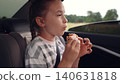 little girl child eating burger in car, happy person, Travel meal solutions for kids, Simple pleasures of eating on the go, Family bonding over fast food, Joyful eating during car rides, Little foodie 140631818