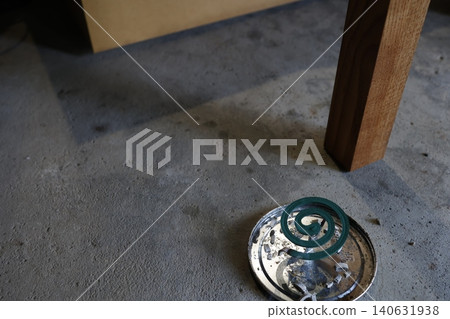Mosquito coil. Green spiral shape. Container and ash. Mosquito coil. Green spiral shape. Container and ash. 140631938