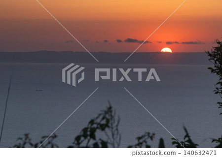 A beautiful sunset view with the sea and island silhouettes bathed in the colors of the setting sun. 140632471