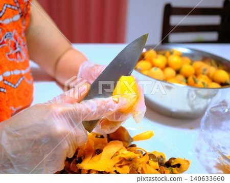 A woman preparing loquats A woman preparing loquats 140633660