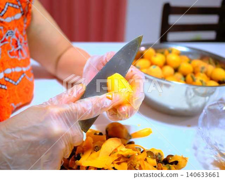 A woman preparing loquats A woman preparing loquats 140633661