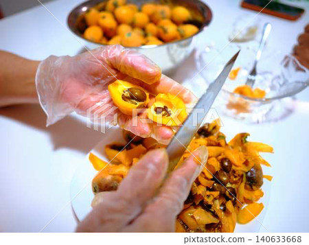 A woman preparing loquats A woman preparing loquats 140633668